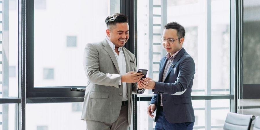 Coworkers sharing HR outsourcing benefits