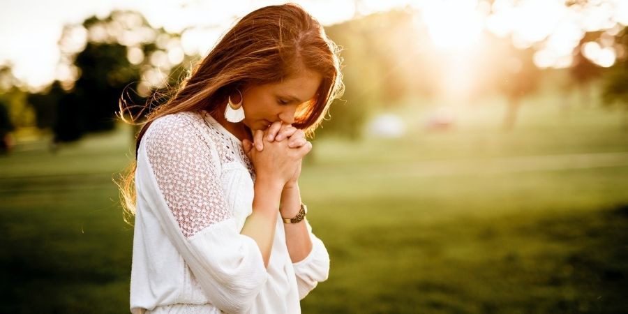 Woman praying outdoors